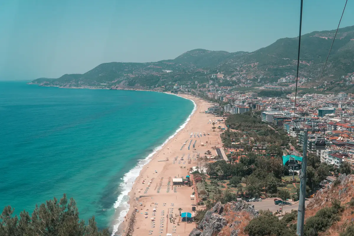 Cleopatra Beach's sand and turquoise water seen from the cable car in Alanya