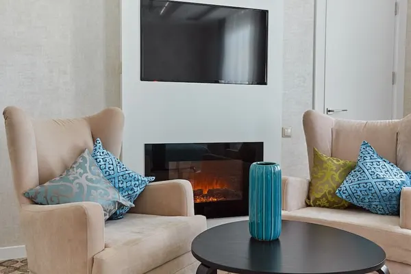 A suite with a fireplace and sitting area